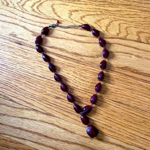 Chunky maroon beads; choker style necklace.